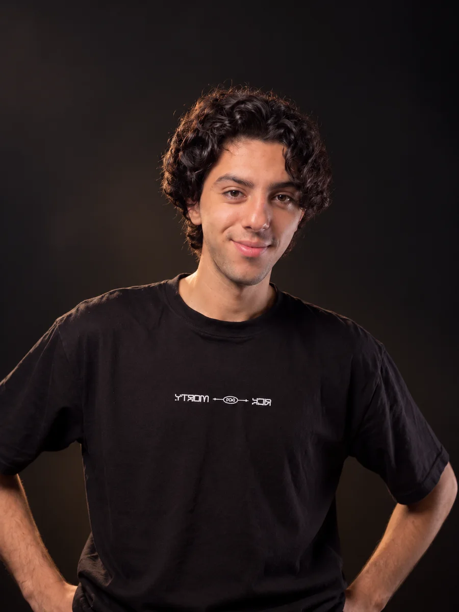 Meshref Ashraf, portrait with curly hair in a black t-shirt.